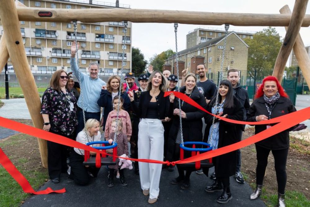 Cllr Ayten Guzel cutting the ribbon at the St James Play Space with a group of people