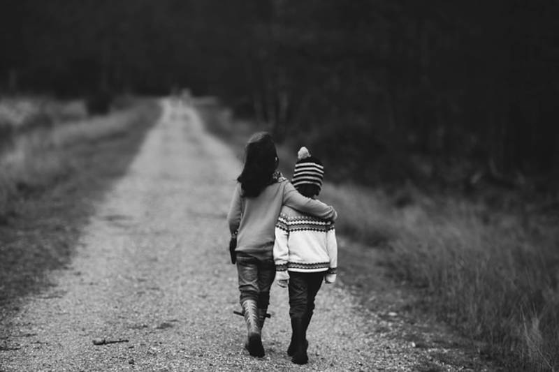 Two children walking along a path