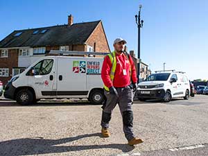 Repairs officer next to an Enfield Repairs Direct van
