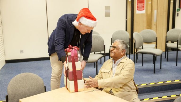 Paul Halpin, Divisional Head Housing Services presenting a raffle prize to a member of the E500
