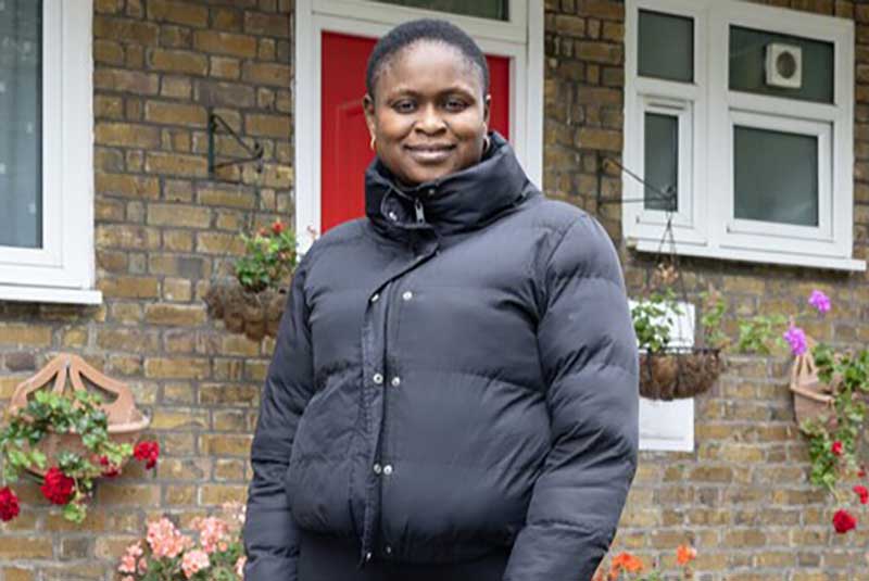 Woman standing in front of a house