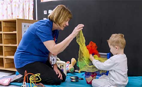 Teacher with young child