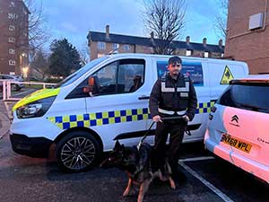 Police dog handler on an estate