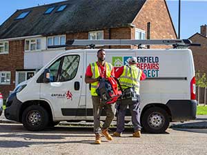 2 men in high-vis jackets next to an Enfield Repairs Direct van