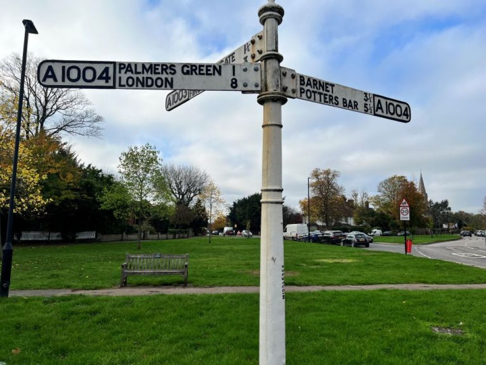 Finger posts on Southgate Green with Christ Church in the background