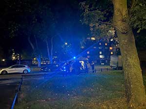 Police van on an estate at night