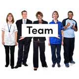 Group of people holding a 'Team' sign