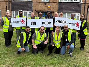 Council officers holding 'Big Door Knock' signage
