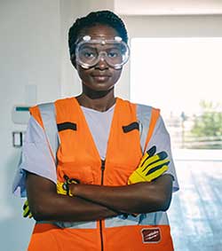 Teenage girl in high-vis jacket wearing protective goggles