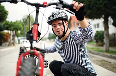 Boy outside with his bike wearing a pendant