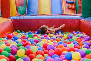 Child in an inflatable ball pit