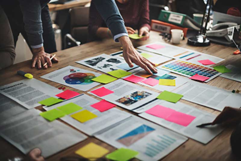Pages laid out on table with post-it notes