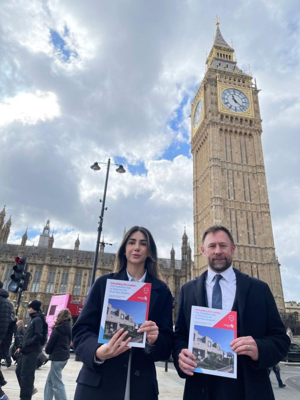 Cllr Guzel and Paul Rickard outside the houses of parliament holding their report
