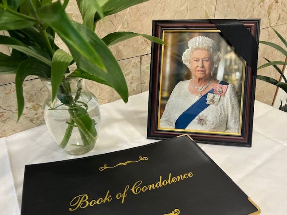A book of condolence next to an image of Queen Elizabeth II at the Civic Centre