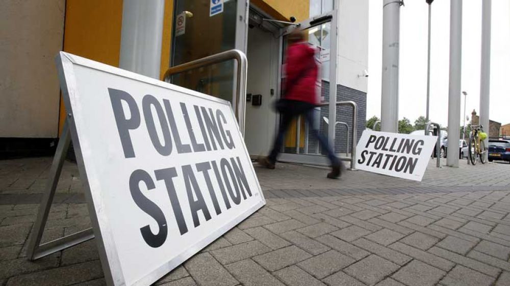 A person enters a polling station in Enfield on election day