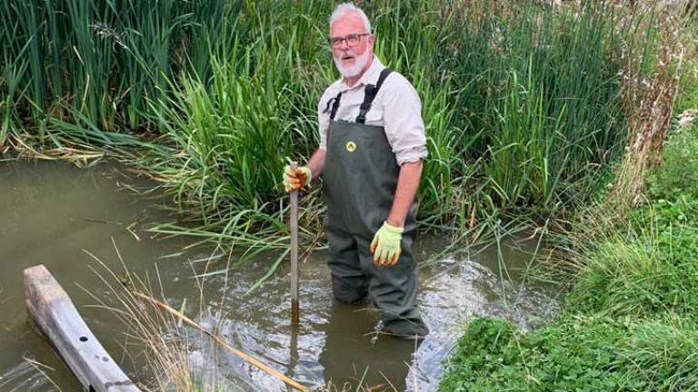 John helping maintain wetlands in his waders 