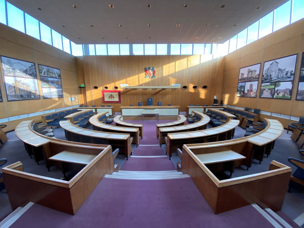 Council chamber with a shaft of light coming through the window