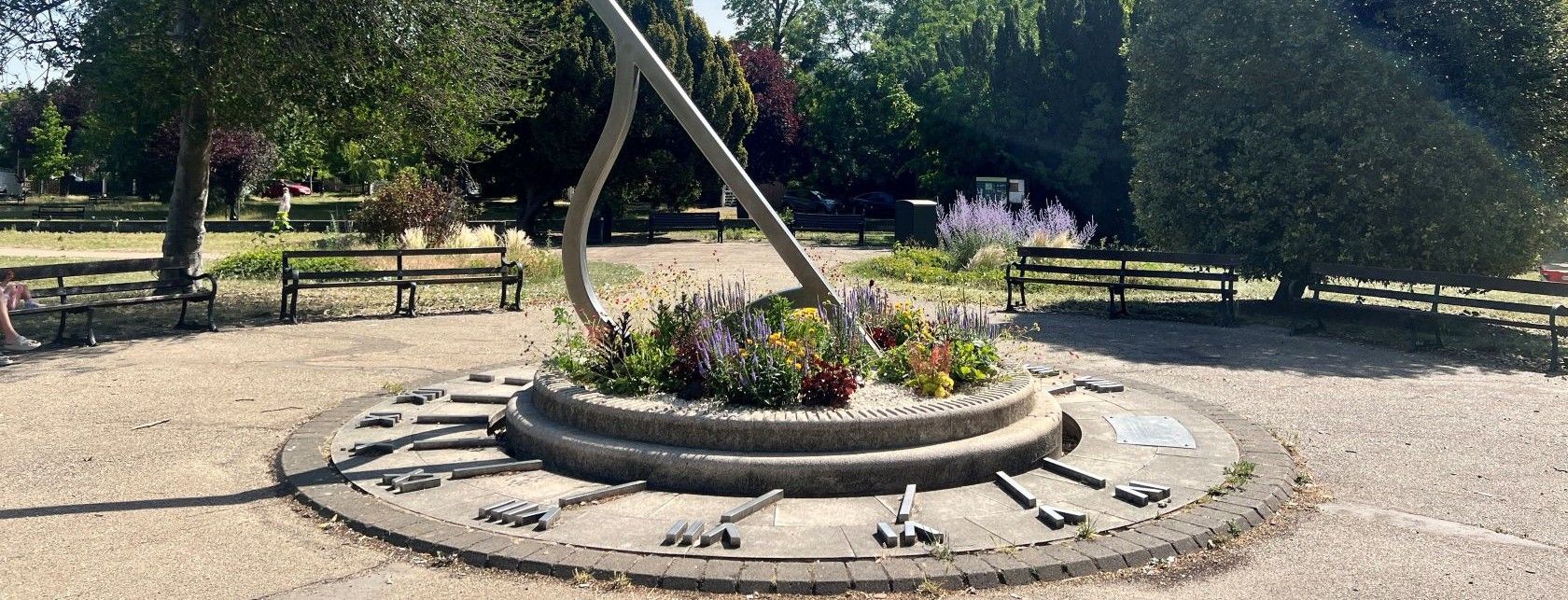 Sundial near the Enfield Town Memorial surrounded by greenery and planting