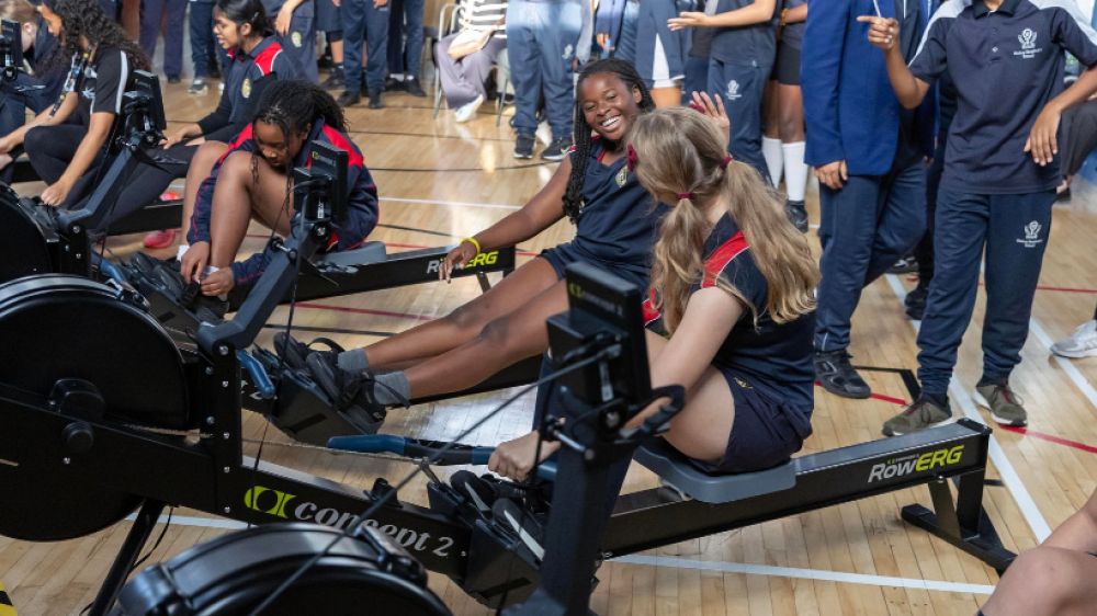 students using indoor rowing machine