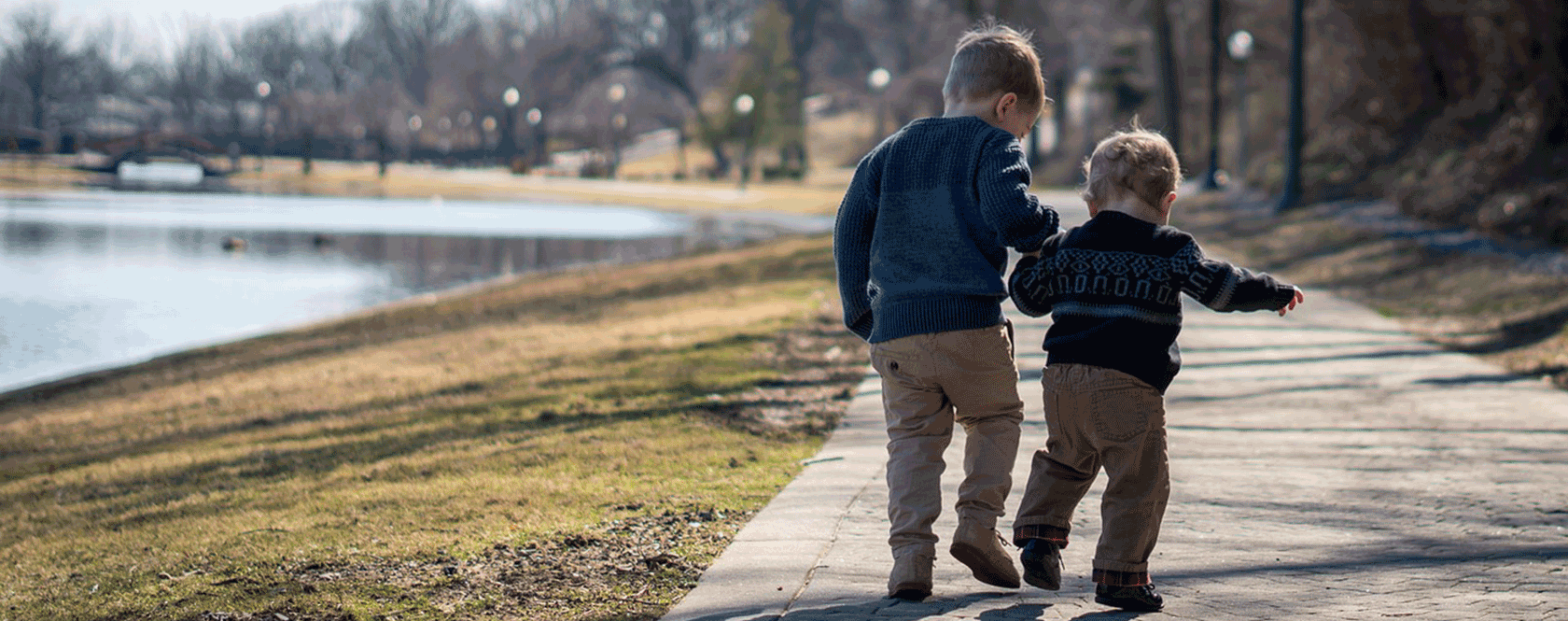 Two boys walking in a park