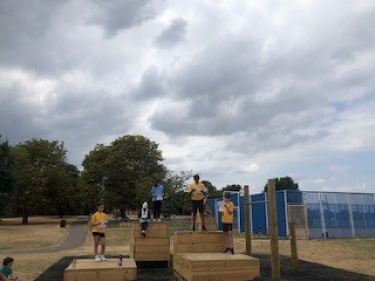 Tottenhall Rec play area with children playing on equipment