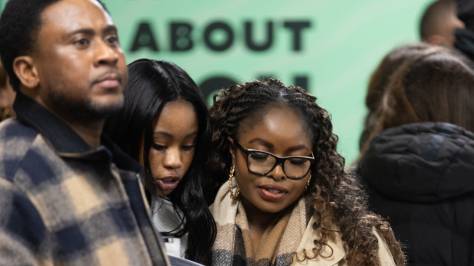 3 teenagers reading a leaflet