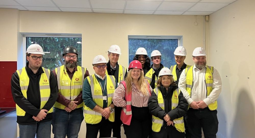 Council officers, Cllr Cazimoglu and the Greyline team stand in a group wearing high viz and hard hats