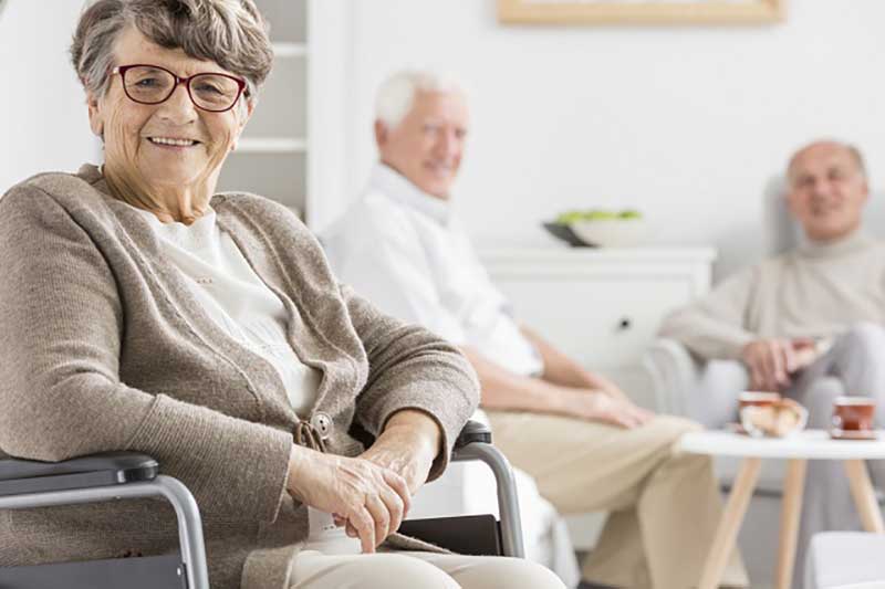 3 smiling people sitting in a room