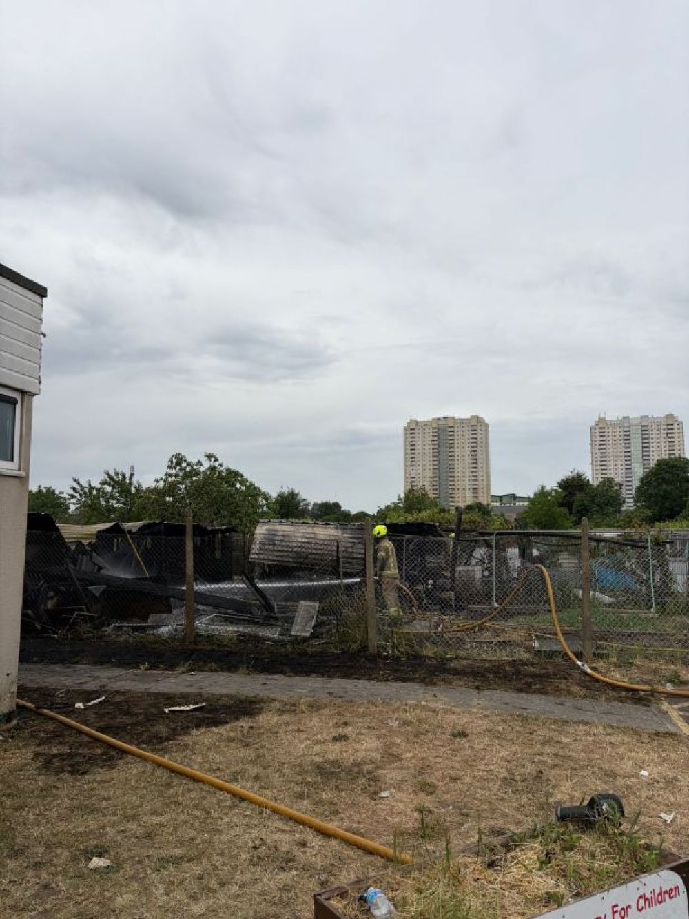 Fire on an allotment being put out by London Fire Brigade