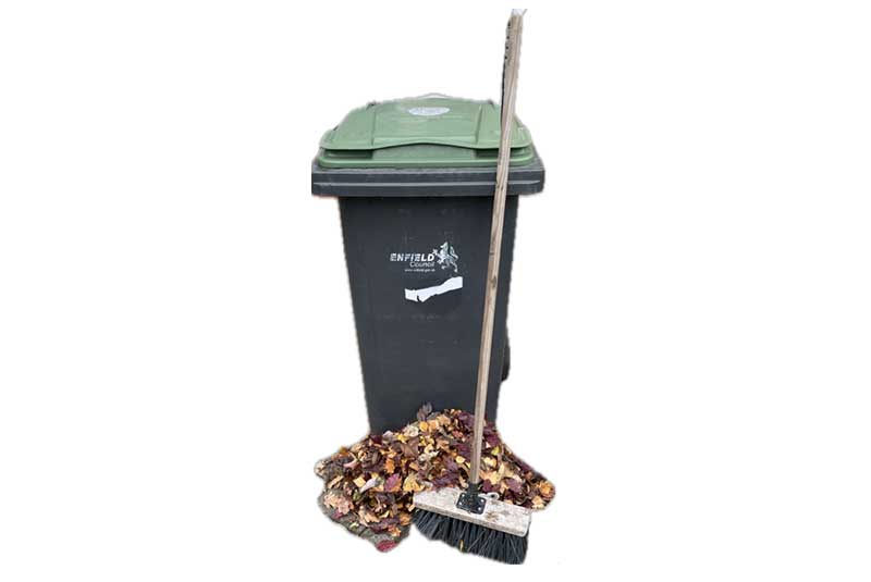 Green garden waste bin with broom