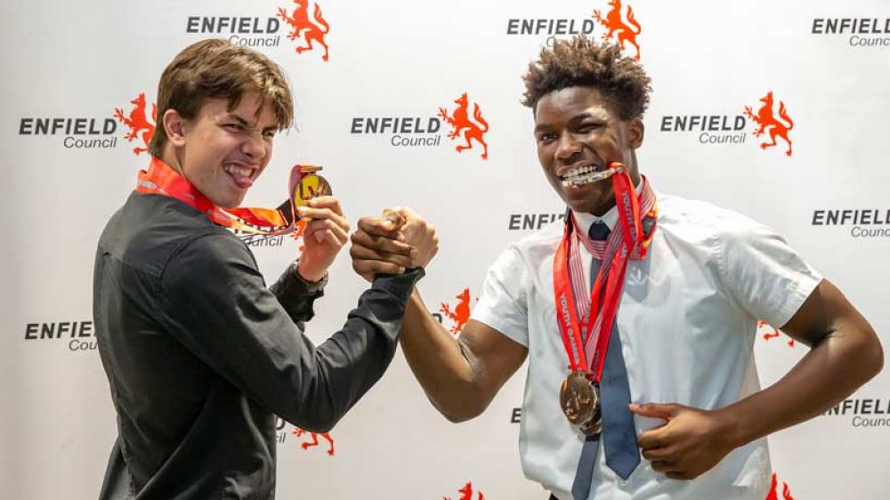 Two athletes show off their medals